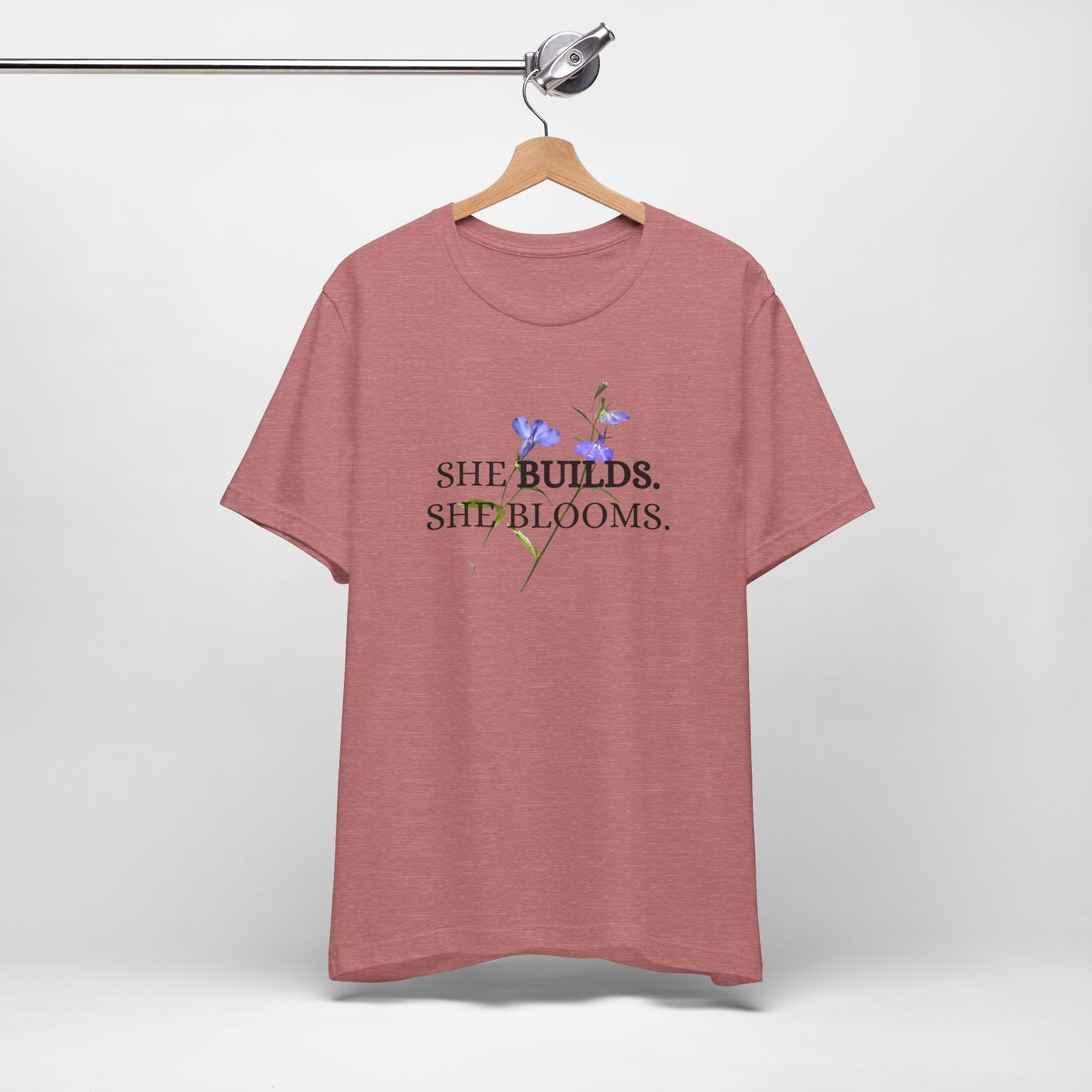 She Builds. She Blooms. - Women's Motivational Tee