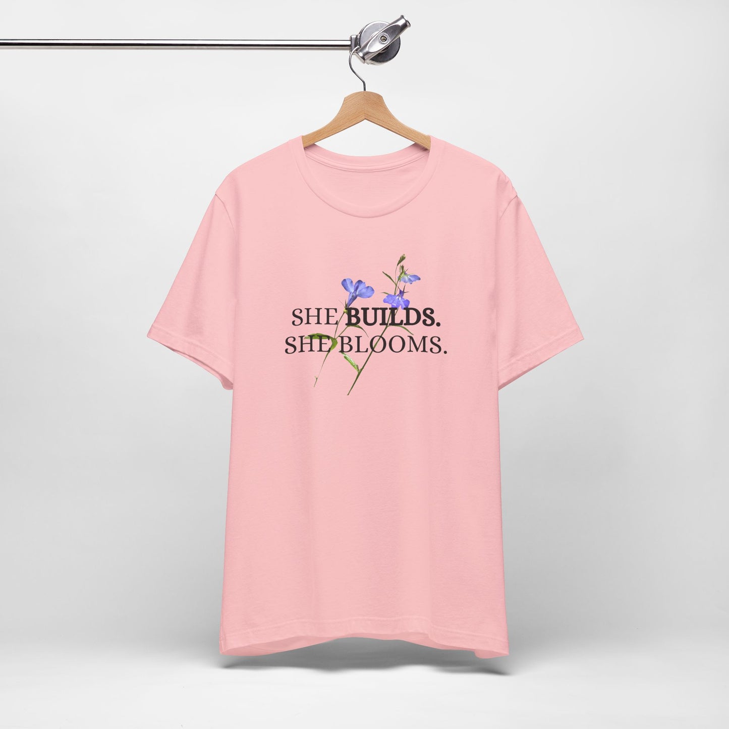 She Builds. She Blooms. - Women's Motivational Tee