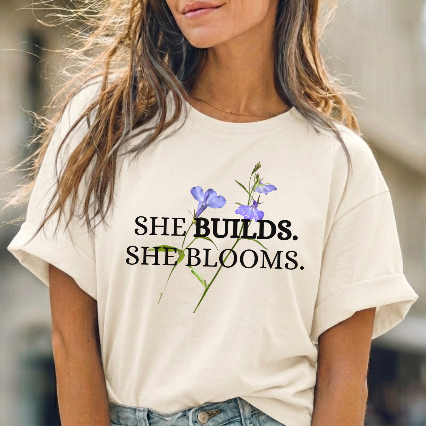 She Builds. She Blooms. - Women's Motivational Tee