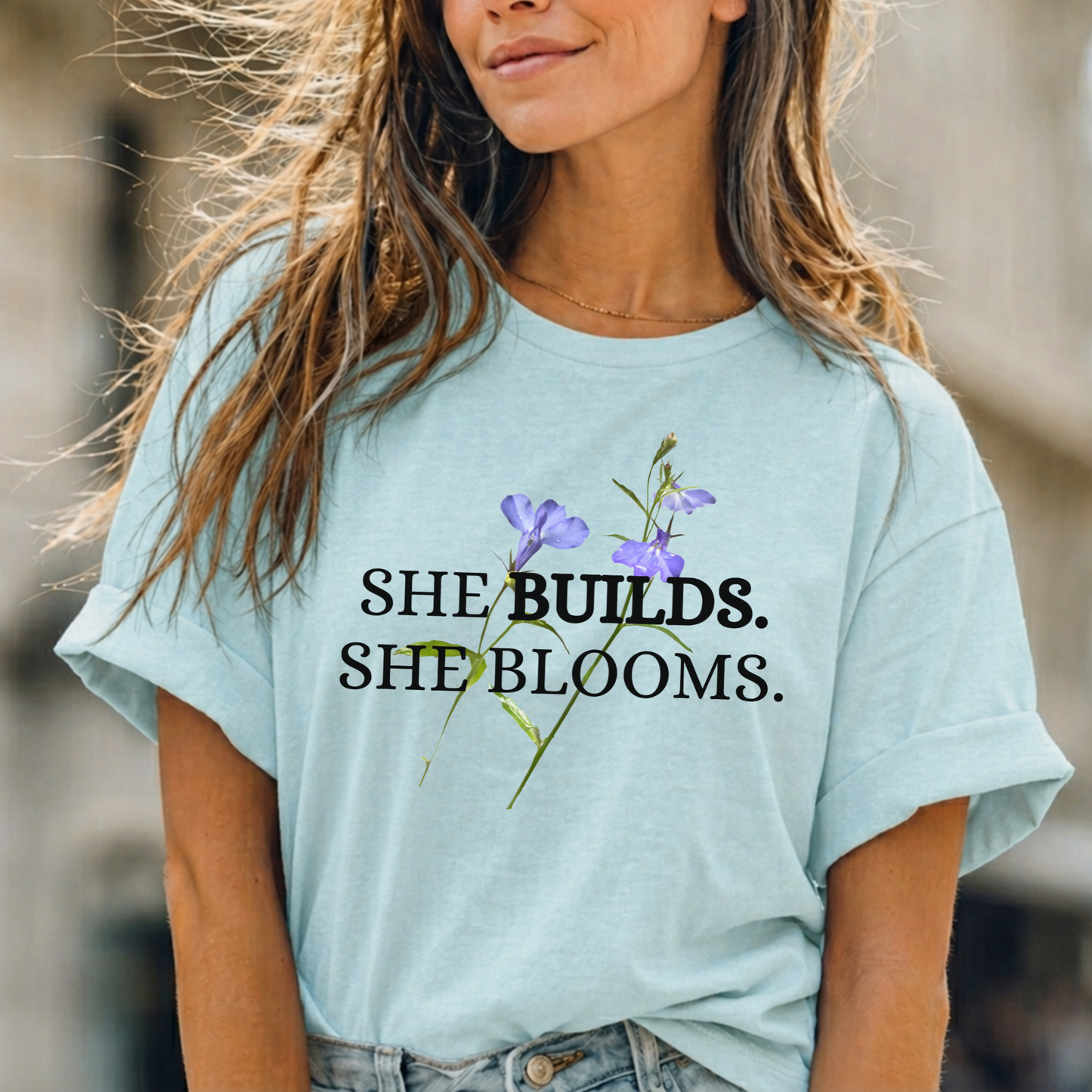 She Builds. She Blooms. - Women's Motivational Tee
