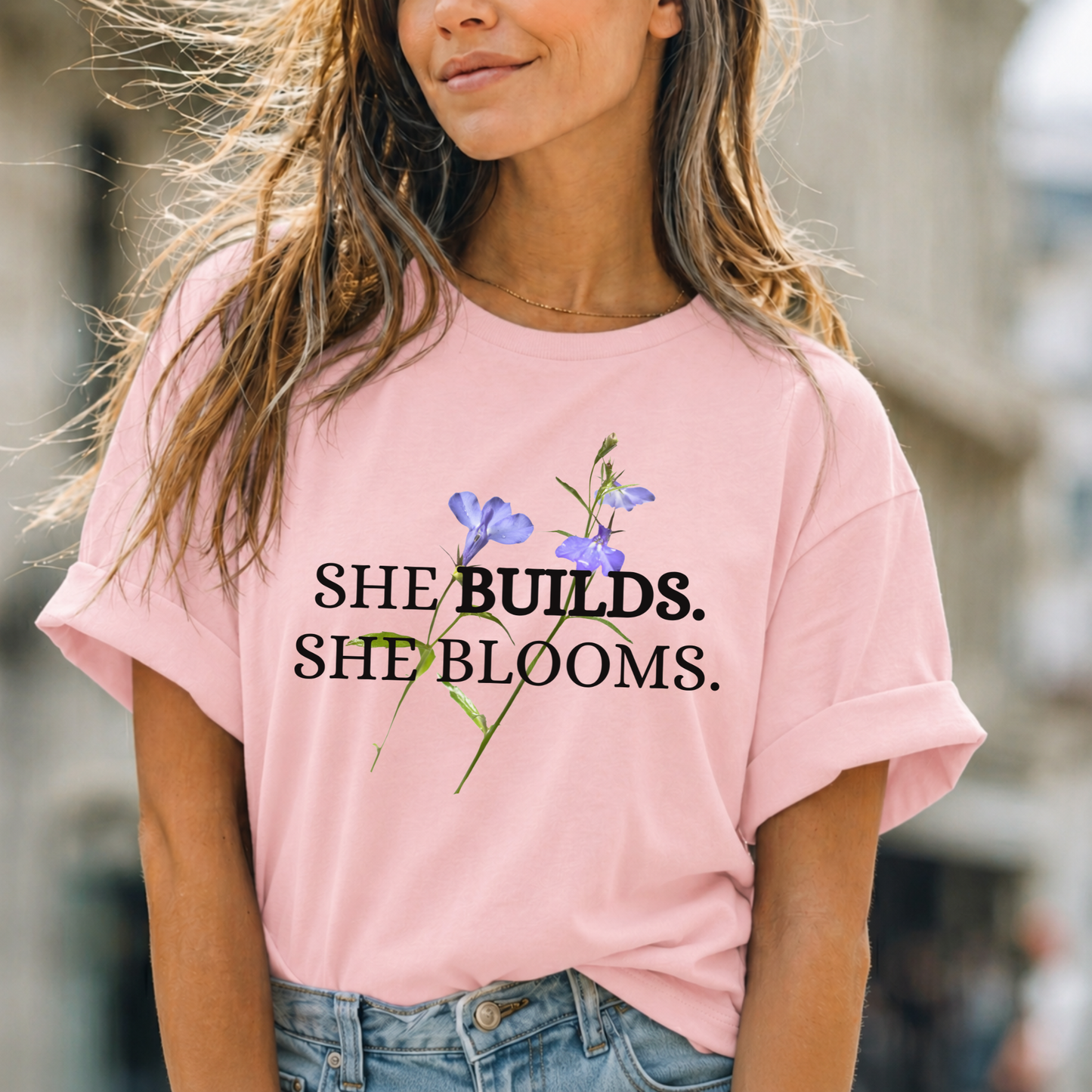 She Builds. She Blooms. - Women's Motivational Tee
