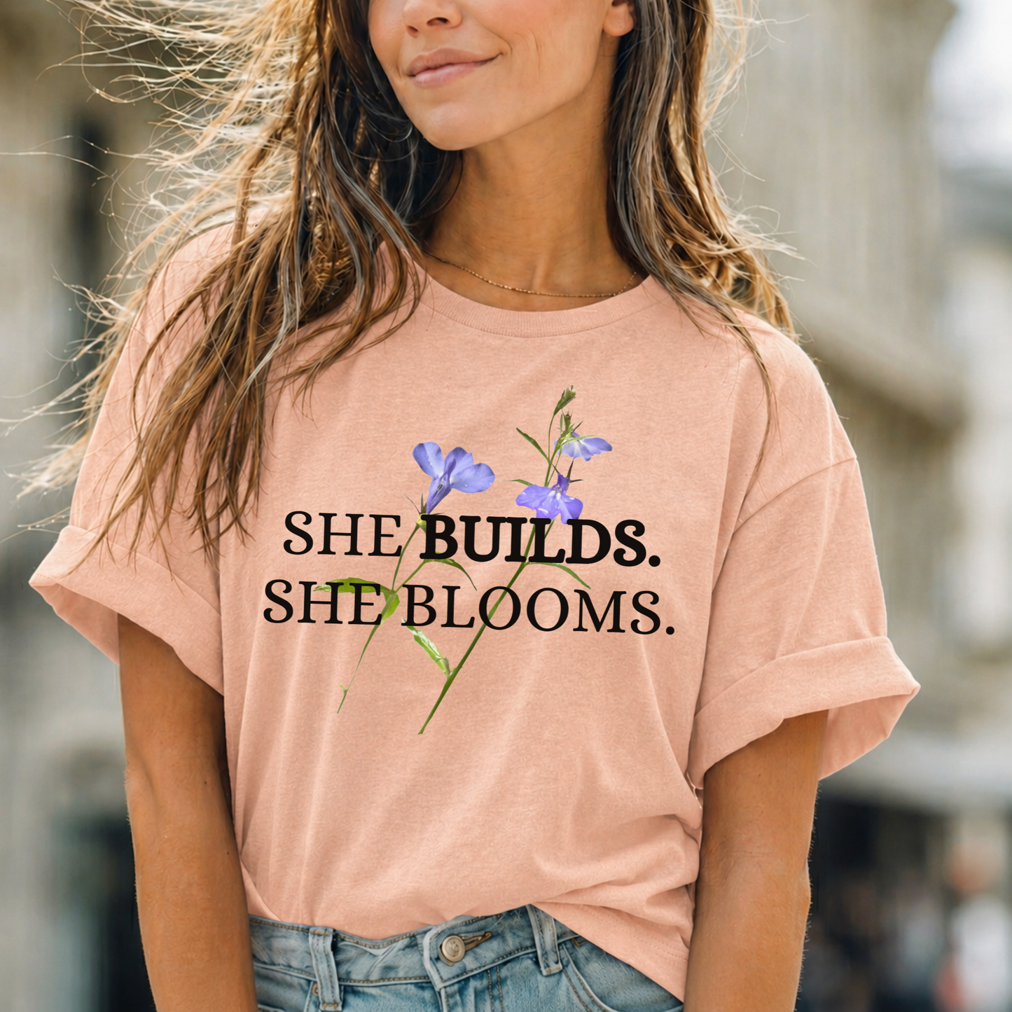 She Builds. She Blooms. - Women's Motivational Tee